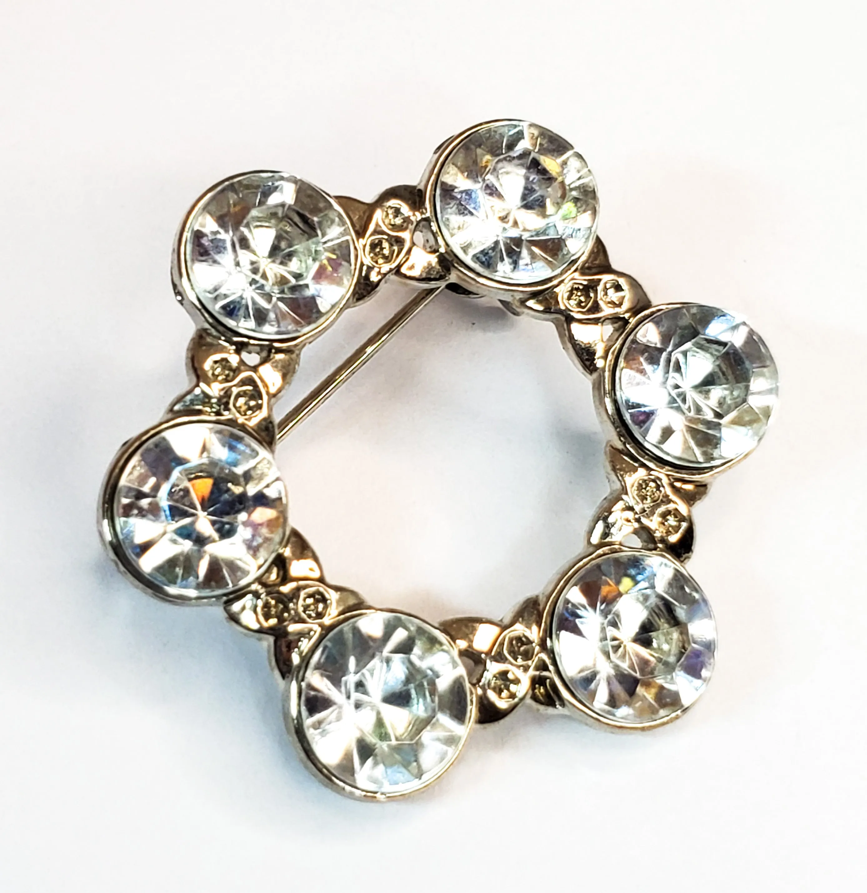 Pave set rhodium plated bright clear rhinestone circle brooch